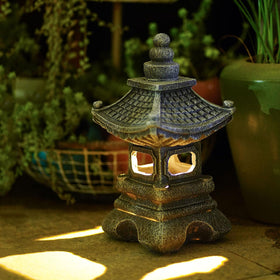 Gardenfans Solar Pagoda Lantern on patio enhancing outdoor ambience
