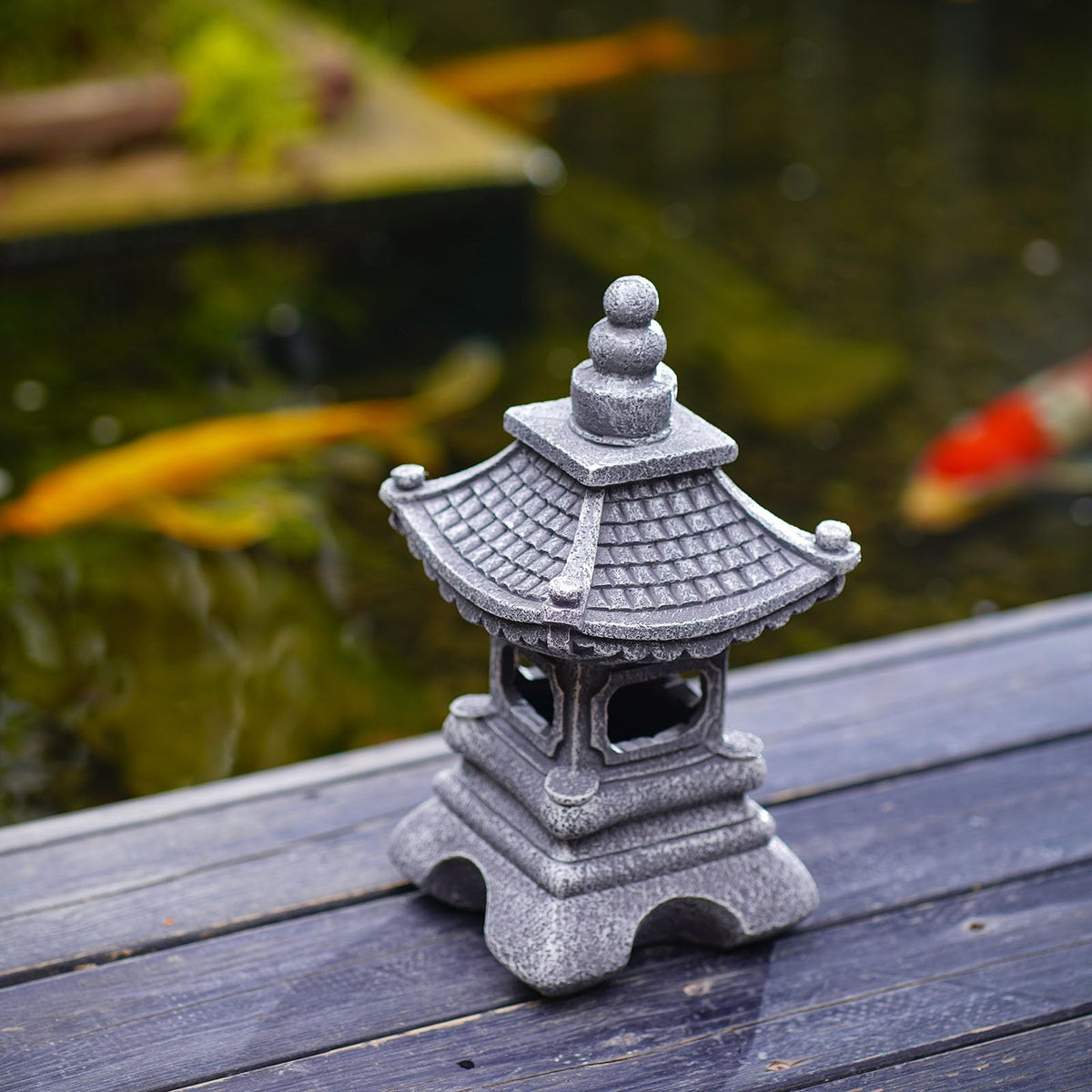 Gardenfans Solar Pagoda Lantern beside rock garden creating calm scenery