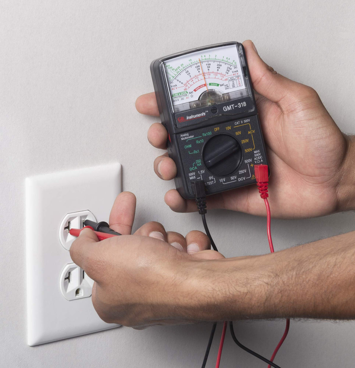 GMT-318 in use testing a wall outlet indoors for proper voltage.