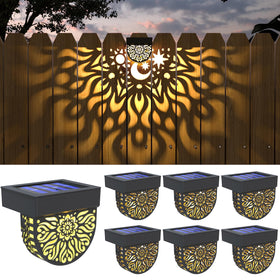 Gardsee solar fence lights cast warm yellow glow along the fence line.