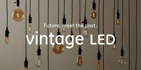 GE Vintage LED amber glass A19 bulb in a chandelier application with warm glow.