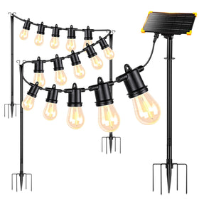 Generic 4-pack outdoor light poles with solar panel illuminate patios at dusk.