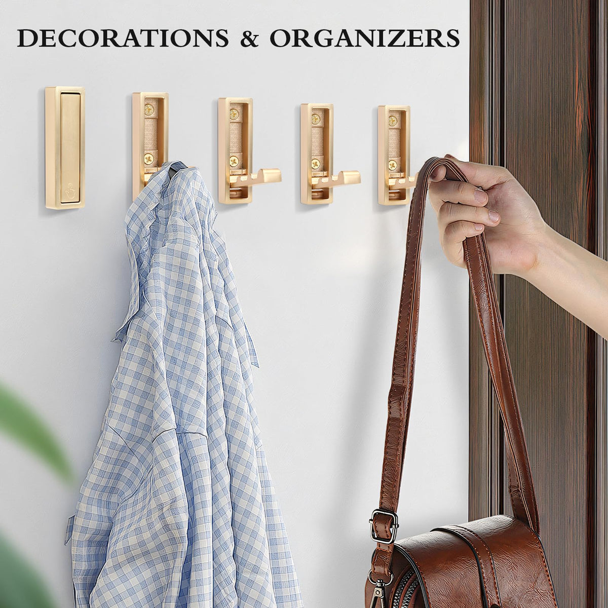 Generic gold wall hooks hanging coats and bags with sturdy support.