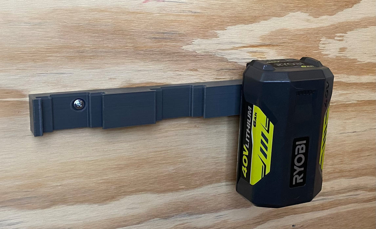Generic Ryobi 40V battery holder mounted on wall for organized workshop storage.