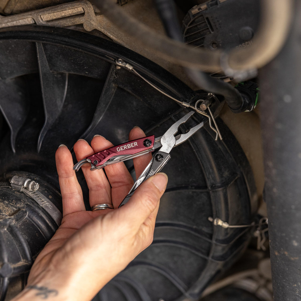 Gerber Dime 12-in-1 pocket knife blade offers versatile cutting in outdoor tasks.
