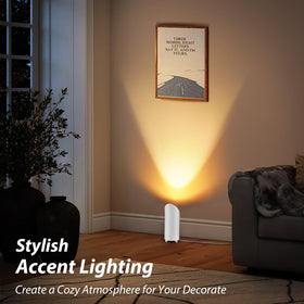 Light directed at corner sofa, plants, and wall art.