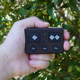 Ghost Controls AXP1 remote with visor clip attached in four orientations for flexible mounting.