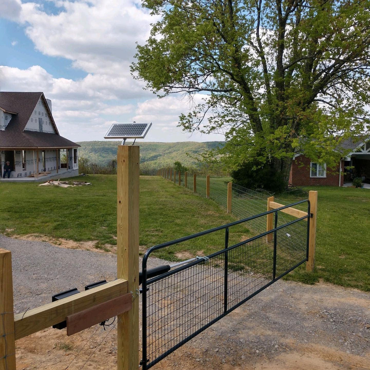 Ghost Controls TSS1XP installation on a driveway with a long-range remote