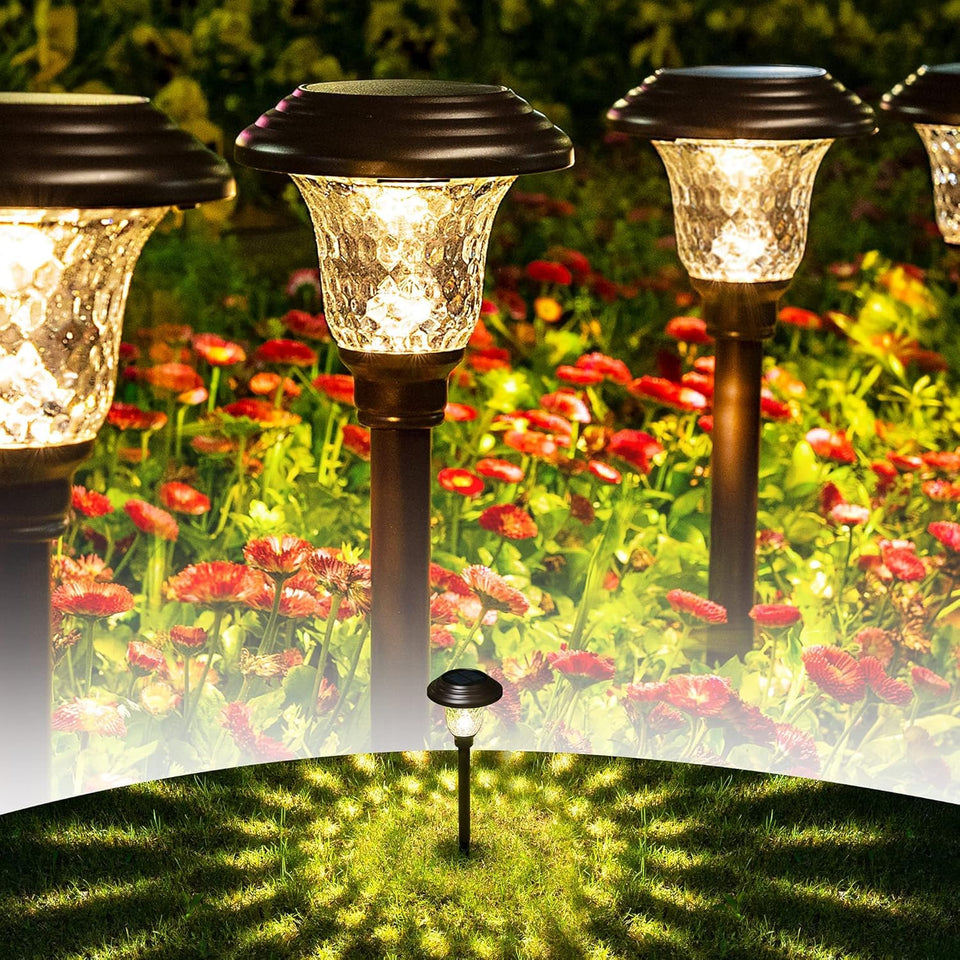GIGALUMI 8-pack solar pathway lights emit warm white glow along a garden path