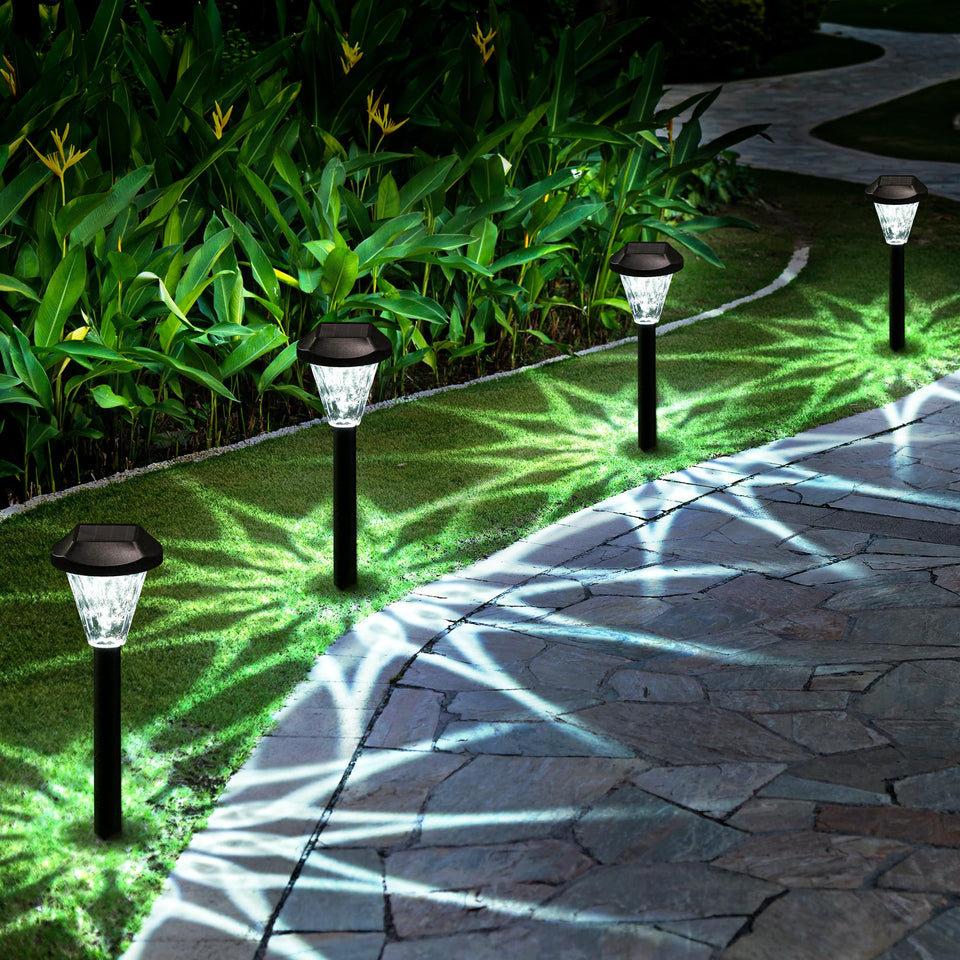 GIGALUMI solar light with star pattern illuminates pathways with a magical glow