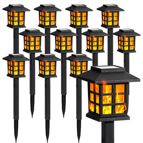 GIGALUMI solar lights outside with flickering flame for warm evening ambiance.