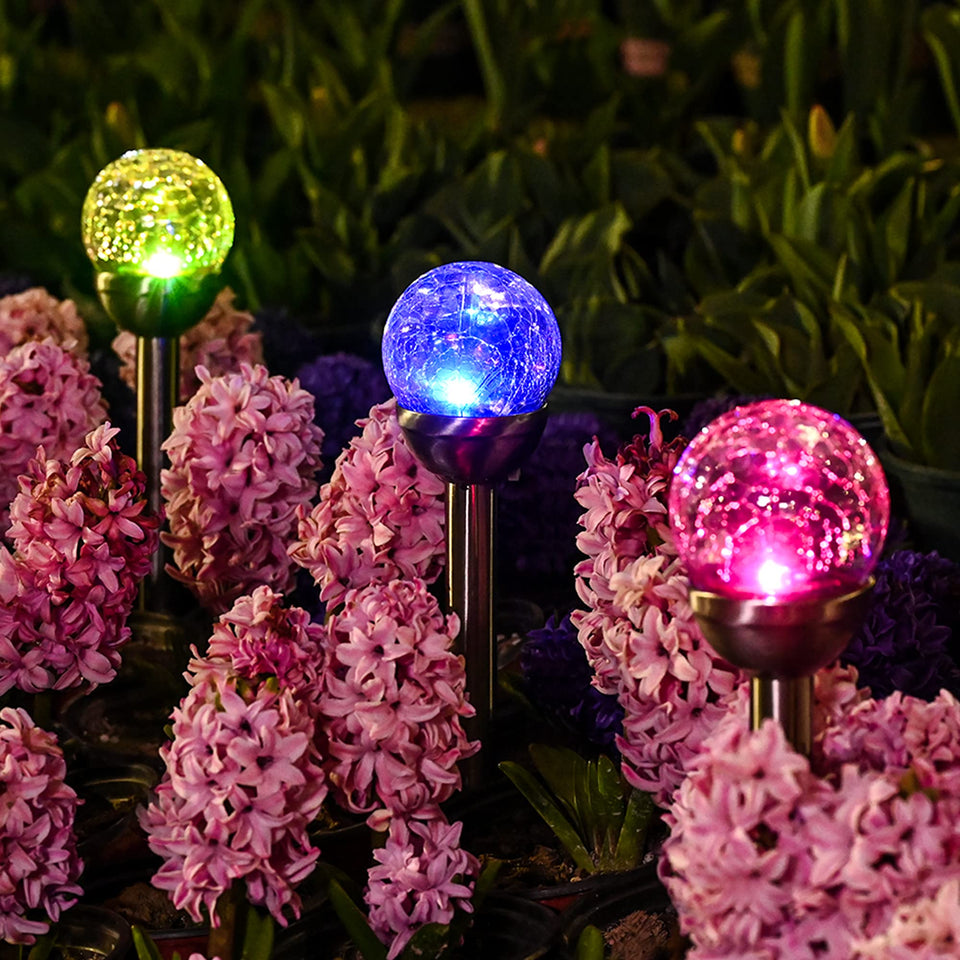 GIGALUMI cracked glass ball light with color-changing LEDs along a garden path
