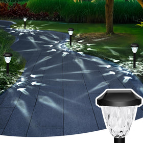 GIGALUMI pattern-design solar lights create decorative lighting along walkway.