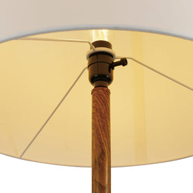 Harrington lamp placed in a bedroom corner for calm illumination
