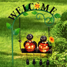 Glooglitter glowing ladybug swing solar light illuminates garden pathways at night