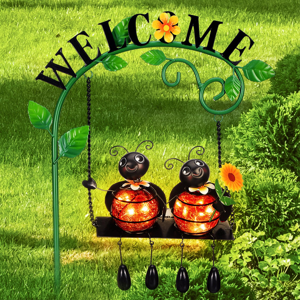 Glooglitter glowing ladybug swing solar light illuminates garden pathways at night