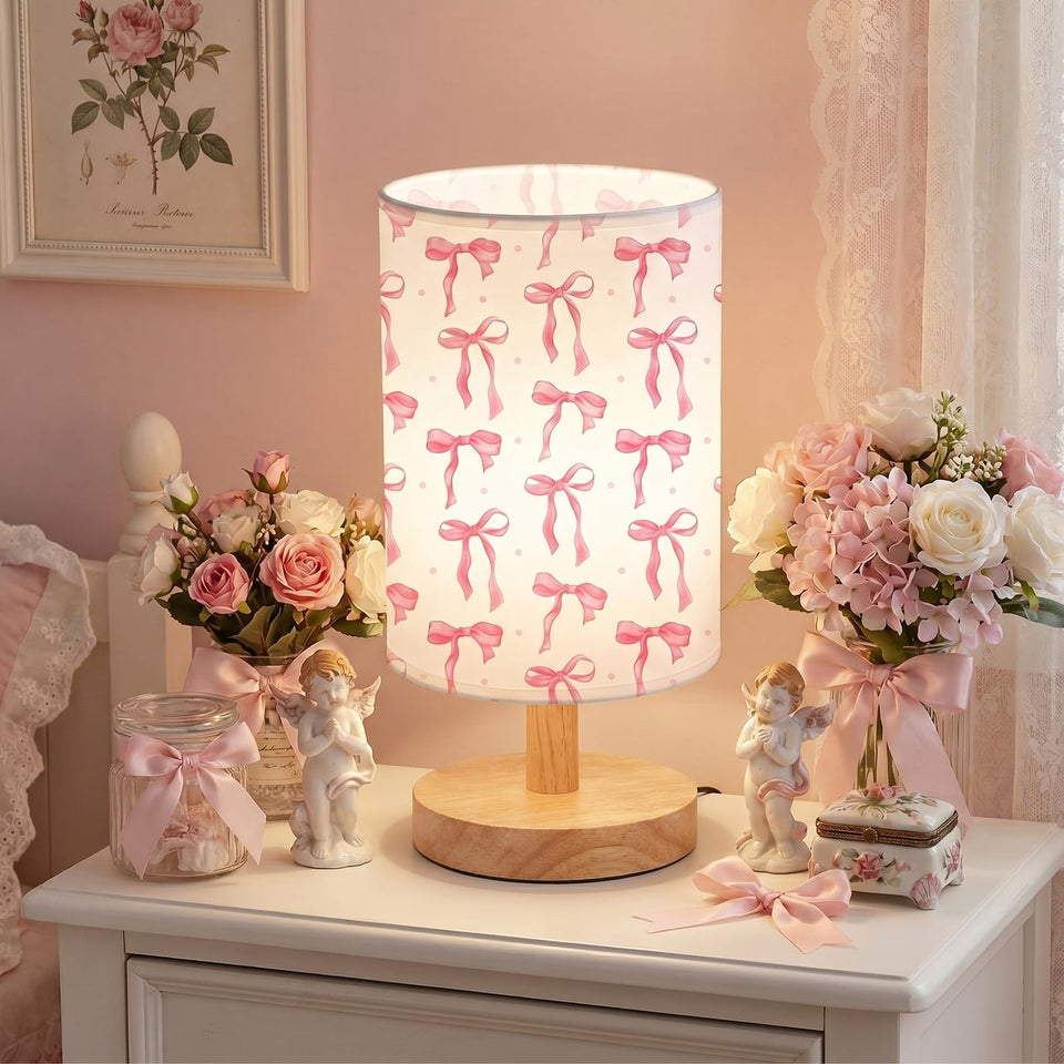 Glooglitter pink bow table lamp with linen shade offering warm, adjustable ambiance.