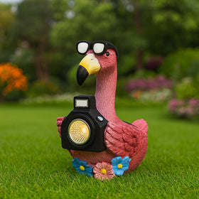 GoGnome solar flamingo camera-light glows in garden at dusk