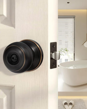 Goldenwarm bronze privacy knob with inside thumb-turn for bedroom use.