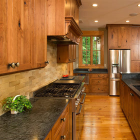 Goo-Ki brass knob on kitchen cabinet, wear-resistant surface for daily use.