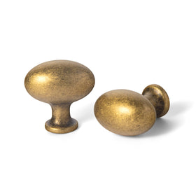 Goo-Ki oval antique brass cabinet knob close-up, enhancing furniture with timeless elegance.
