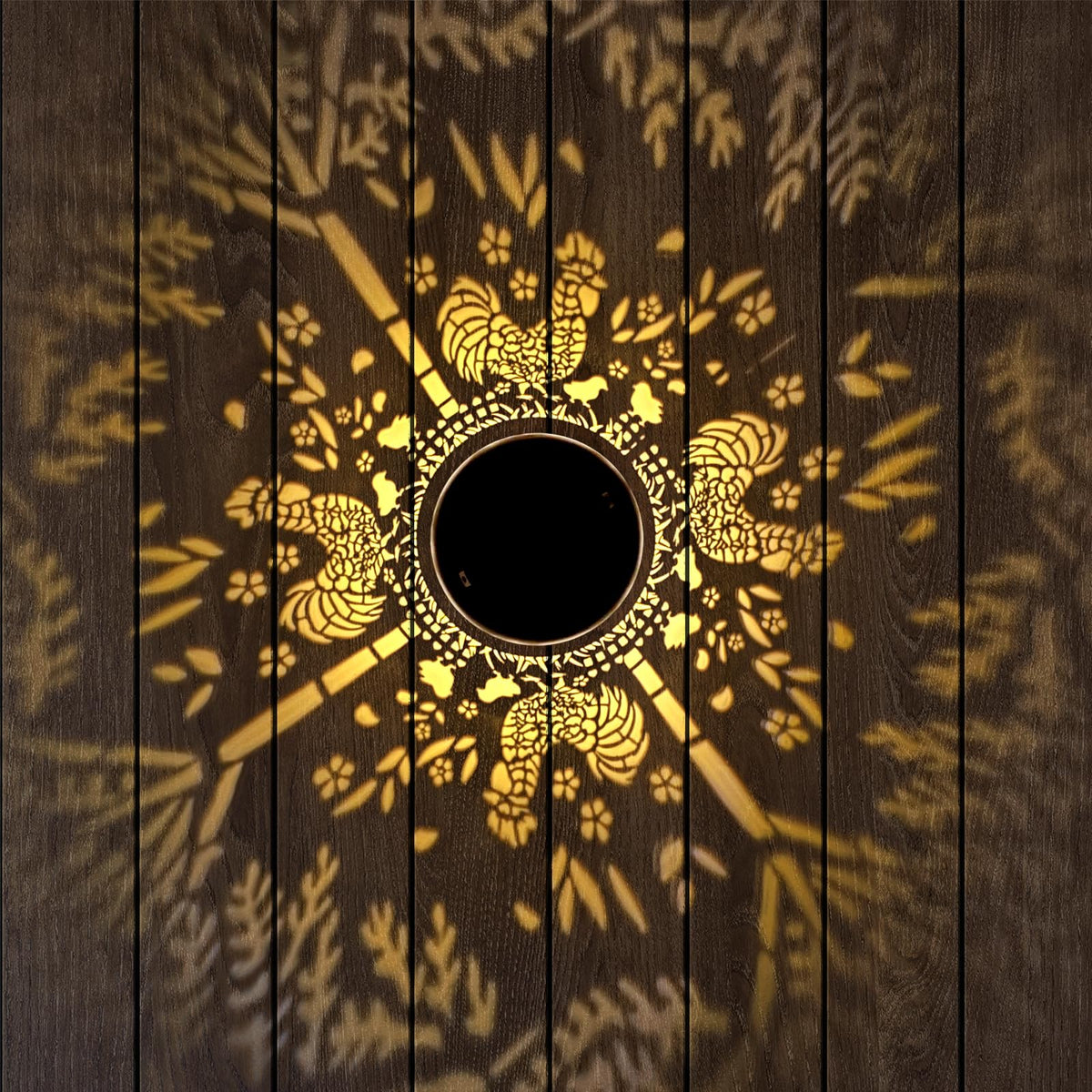 Gotome rooster pattern projection lantern enhances nighttime garden mood.