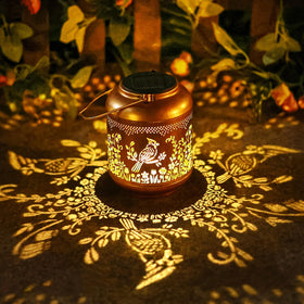 Gr8Gardens Cardinal solar lantern hanging in garden with warm ambient glow.