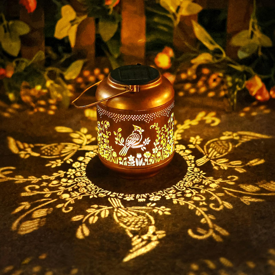 Gr8Gardens Cardinal solar lantern hanging in garden with warm ambient glow.