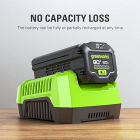 Greenworks 80V battery in use powering an outdoor tool.