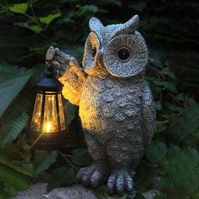 GUANFU owl garden statue with solar lantern lighting a warm outdoor path.