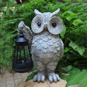Close-up of GUANFU owl statue showing detailed feather texture.