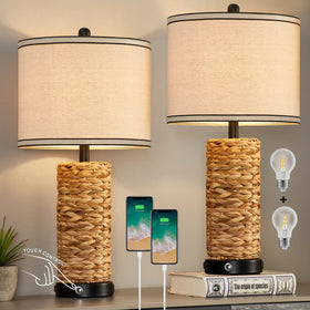 GyroVu rattan table lamp base and shade glow in a cozy bedroom