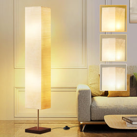 GyroVu floor lamp with beige shade and walnut base in a cozy living room.