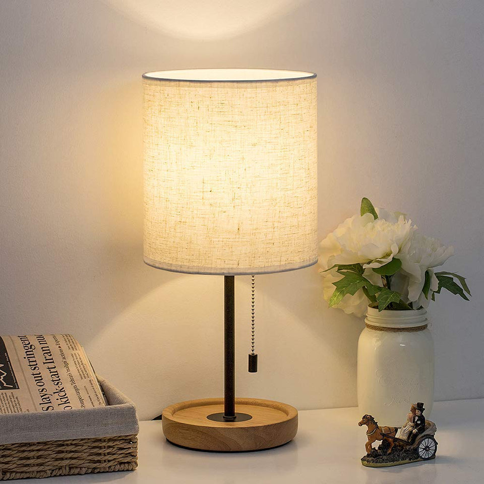 HAITRAL bedside lamp with wood base for warm, cozy lighting.
