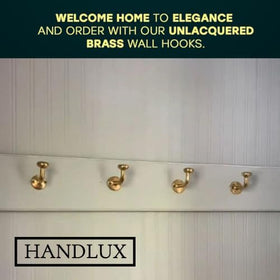 HANDLUX wall hooks on wall with coats and towels for organized entryway