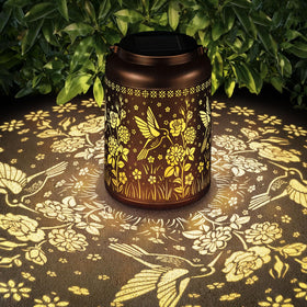 HEGUD hummingbird solar lantern glows warmly for outdoor evenings.