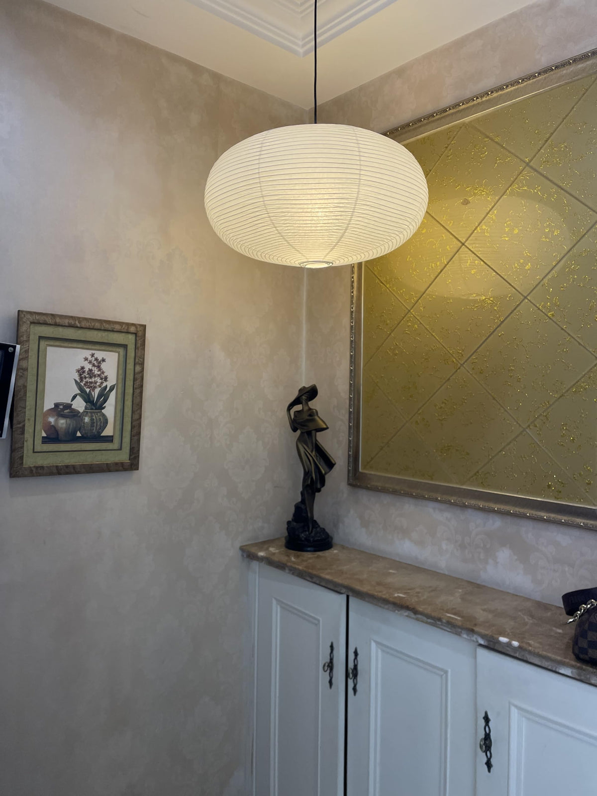 Henjjras white chandelier shade above sofa arrangement.