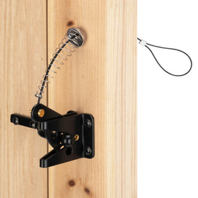 Hillmaster self-closing gate latch installed on a wooden fence for pool area security.
