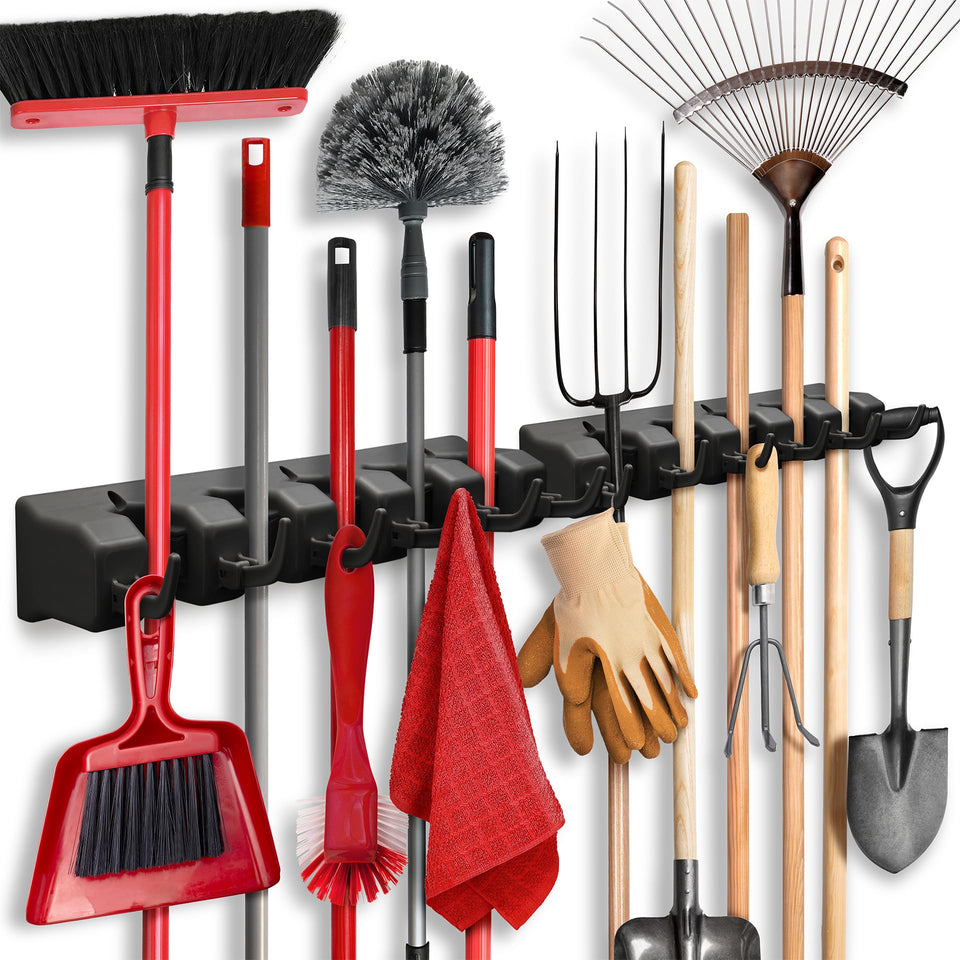 HOME IT broom and mop holder on wall with five slots and six hooks for organized tools.