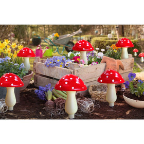 Homeleo red mushroom solar light used as patio border lighting for charm and safety.
