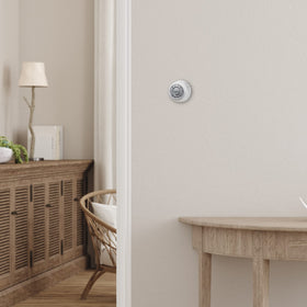Honeywell Home round thermostat mercury-free design with decorative ring.