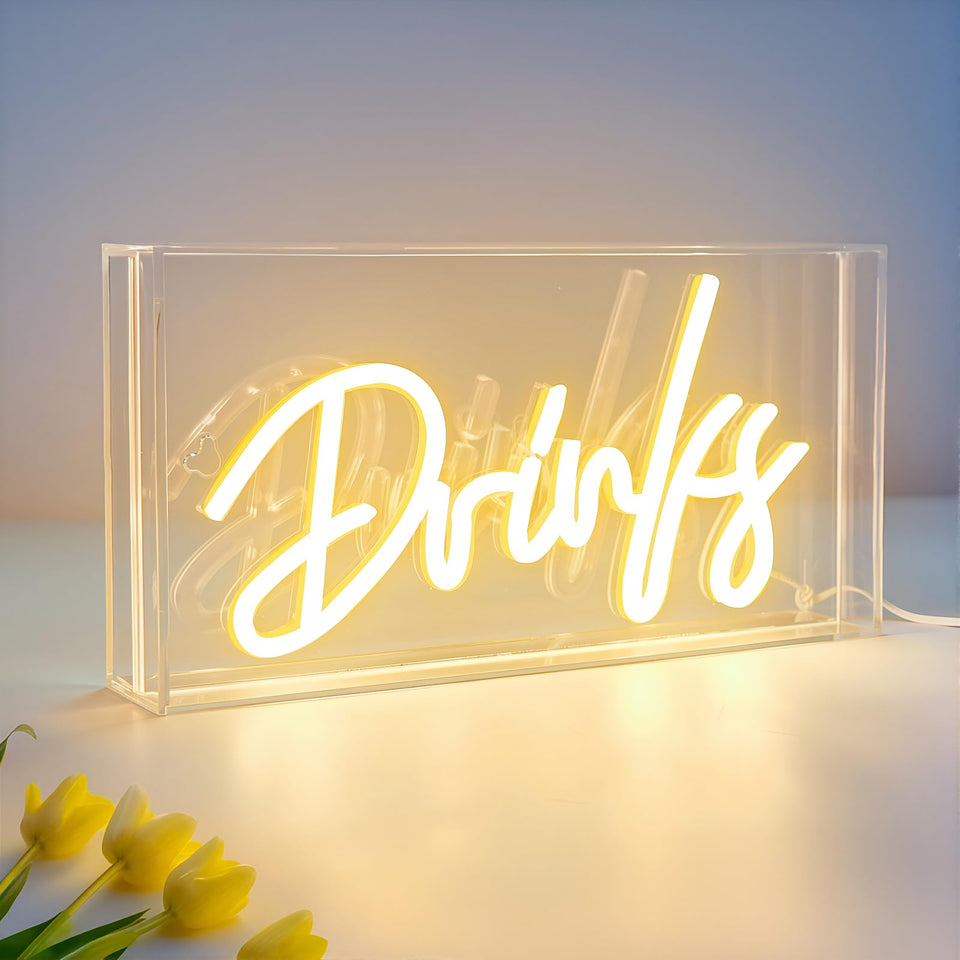 HOSITARK Drinks neon sign on desk creating a cozy home bar ambiance.