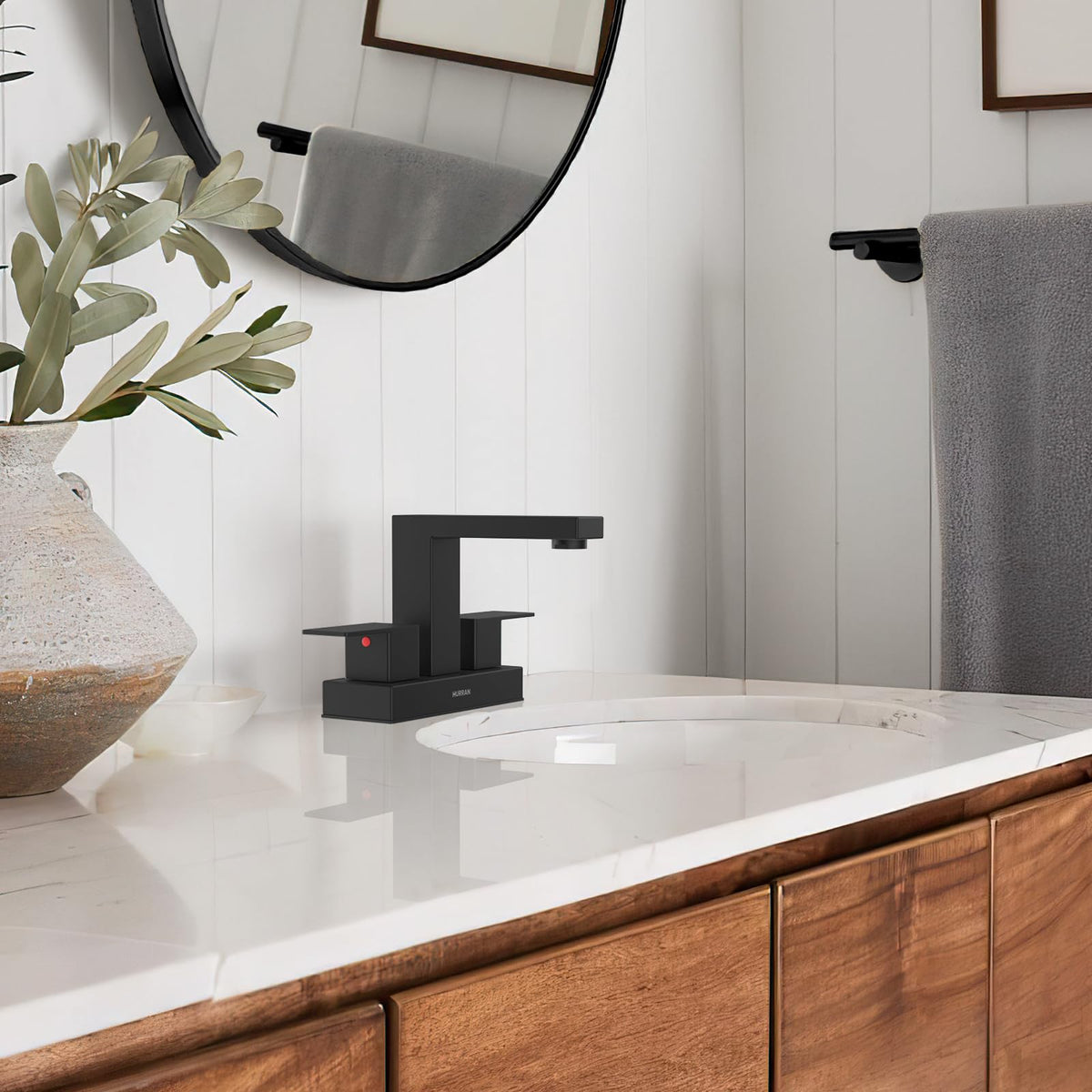Hurran matte black faucet mounted on sink in a modern bathroom