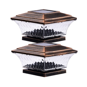HUYIENO solar post cap light 2-pack illuminating a fence line at dusk