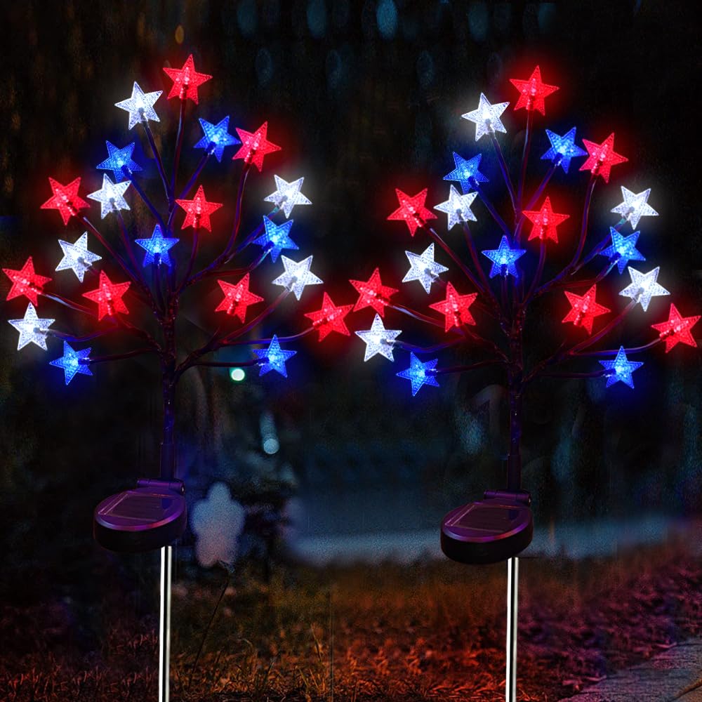 ILOVERD solar star stake lights in red, white and blue lighting a walkway at dusk