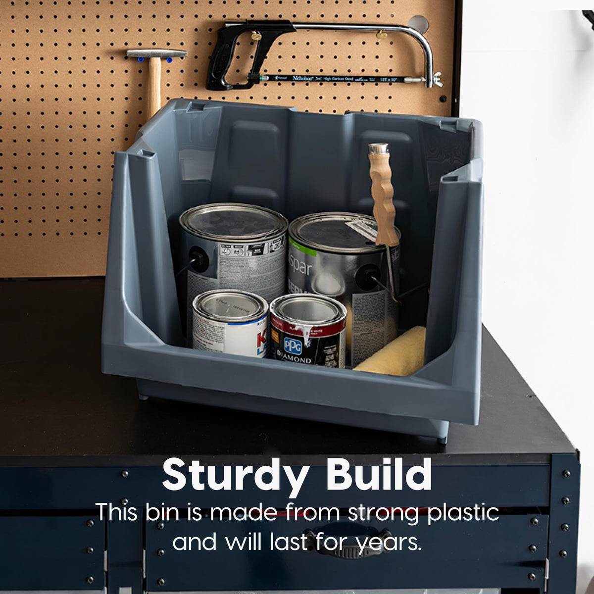 IRIS USA garage storage bin keeps tools and hose neatly organized.