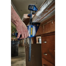 IRWIN Quick-Grip 12inch bar clamp upright on a work surface with adjustable foot.