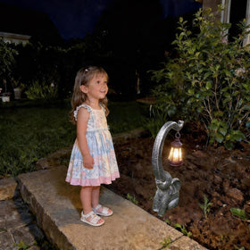 LED filament light glows softly from IVCOOLE elephant garden statue.