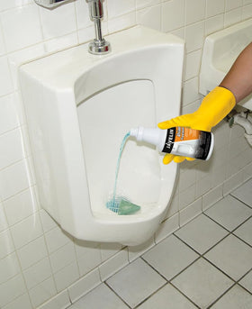Javelin Urinal Drain Treatment applied near the drain prevents clogs and odors in commercial restrooms