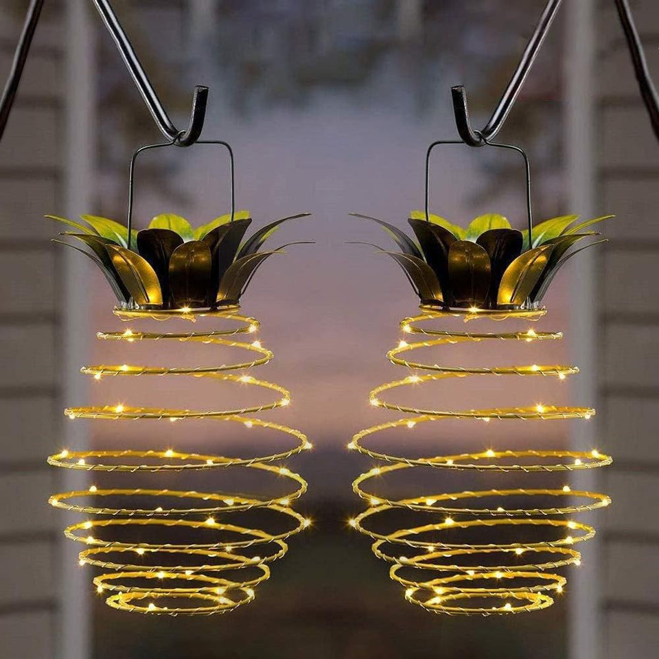 JHPGEOE pineapple lanterns illuminate a garden path with warm, energy-saving glow.